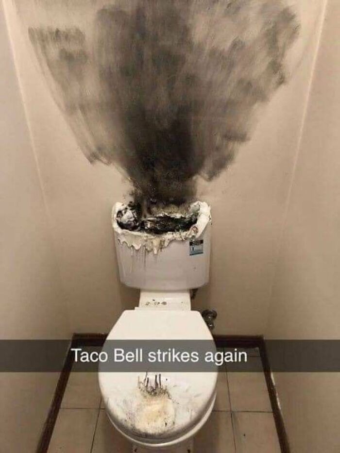 A cringe image of a toilet with smoke and charring, suggesting a dramatic incident, with text Taco Bell strikes again.