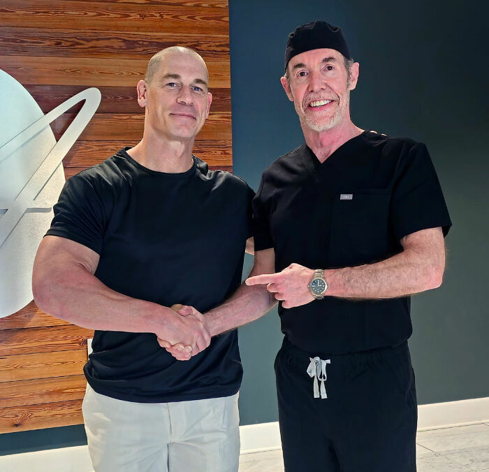 John Cena shaking hands with a doctor, revealing his hair transplant results.