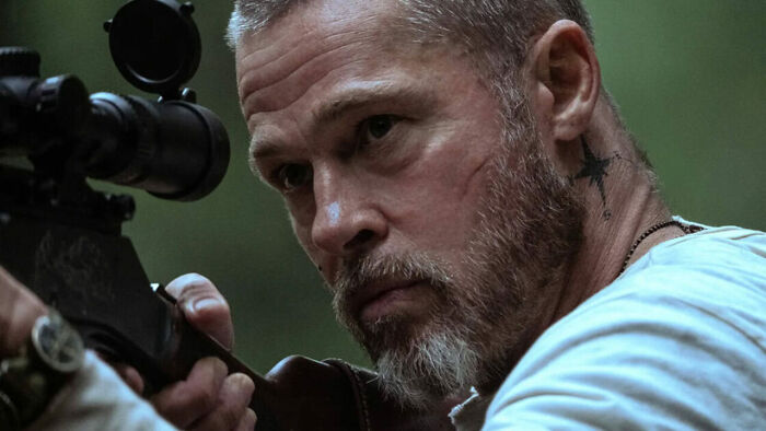 Brad Pitt aiming sniper rifle with rugged survival look Brad Pitt aiming sniper rifle with rugged survival look