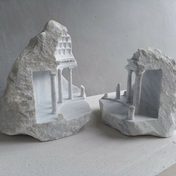 Artist carves two tiny architectural models of classical buildings into solid stone, split apart.
