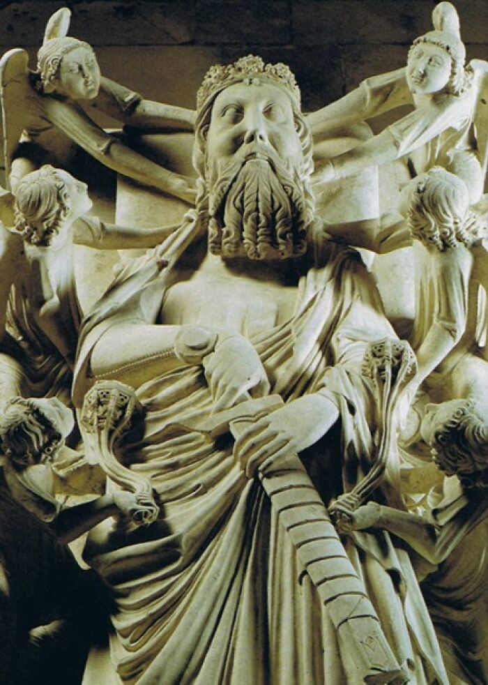 Medieval sculpture showing a bearded king surrounded by angels symbolizing historical revenge
