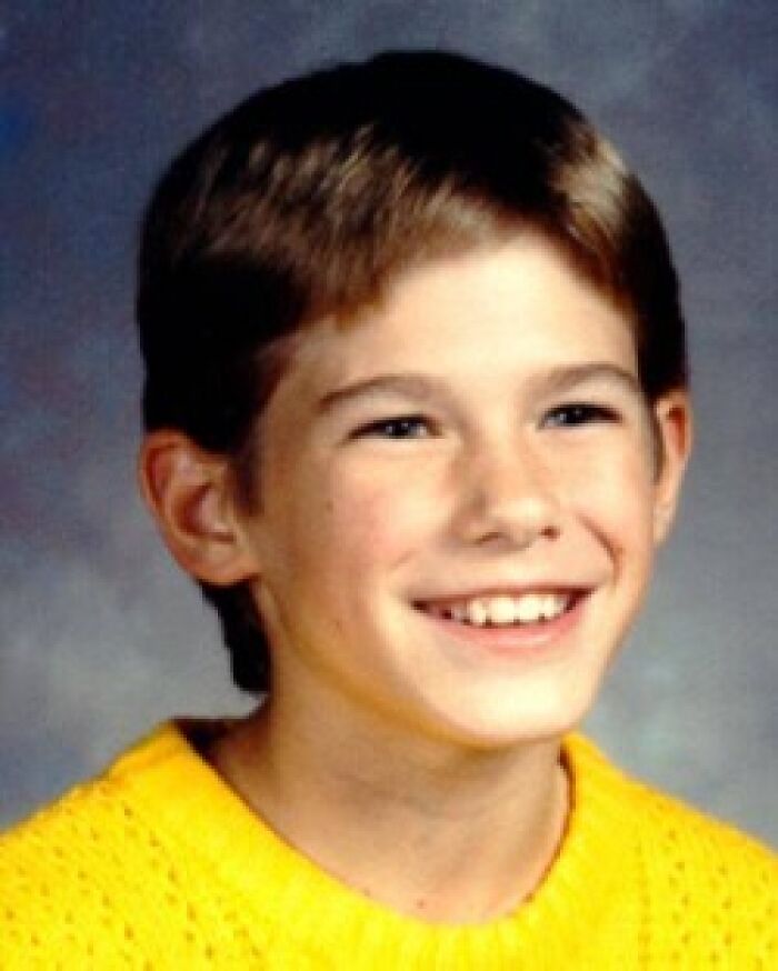 Smiling boy with brown hair and a yellow sweater, a person involved in a solved mystery.