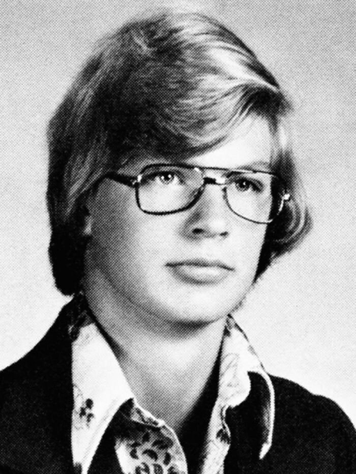 Black and white portrait of a young man with glasses