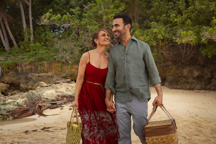 Couple holding hands walking on beach in Office Romance movie Couple holding hands walking on beach in Office Romance movie