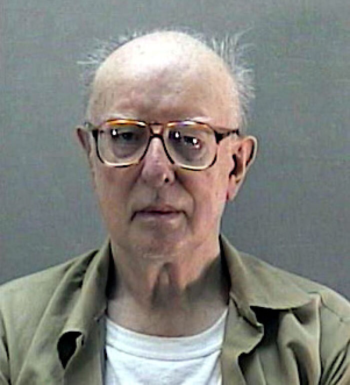 Mugshot of an older man with glasses and thinning hair, connected to an unsolved mystery now solved.
