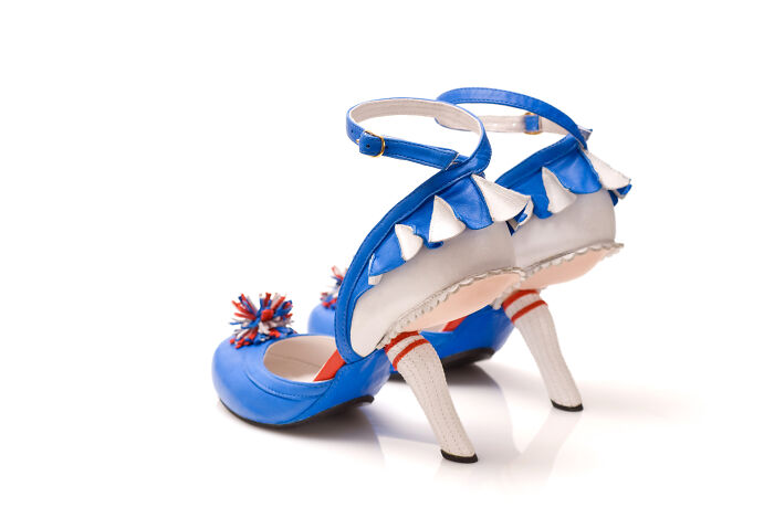 Blue, white, and red creative and imaginative shoes by Kobi Levi, featuring a cheerleader design with socks and pom-poms.