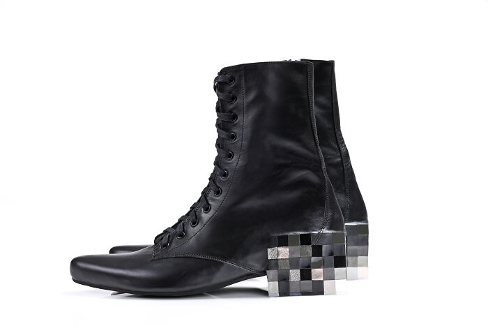 Creative and imaginative Kobi Levi shoe designs featuring black combat boots with a pixelated silver and black heel.
