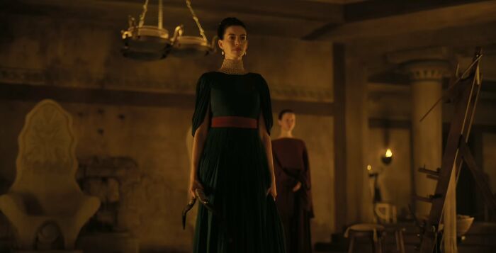 Woman in green dress holding dagger in historical setting from The Odyssey Woman in green dress holding dagger in historical setting from The Odyssey