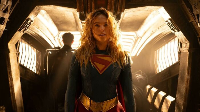 Supergirl star in costume inside futuristic spaceship with strong sunlight