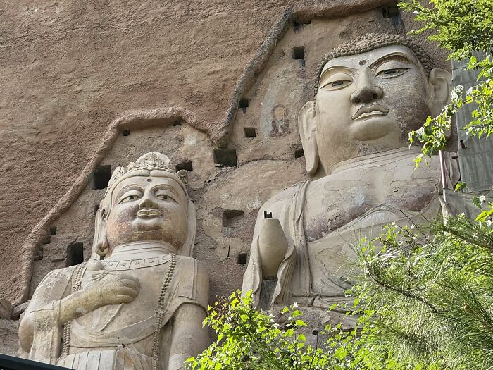 Close-up of ancient Buddha statues carved into a mountain, a magnificent sight for travelers in China.