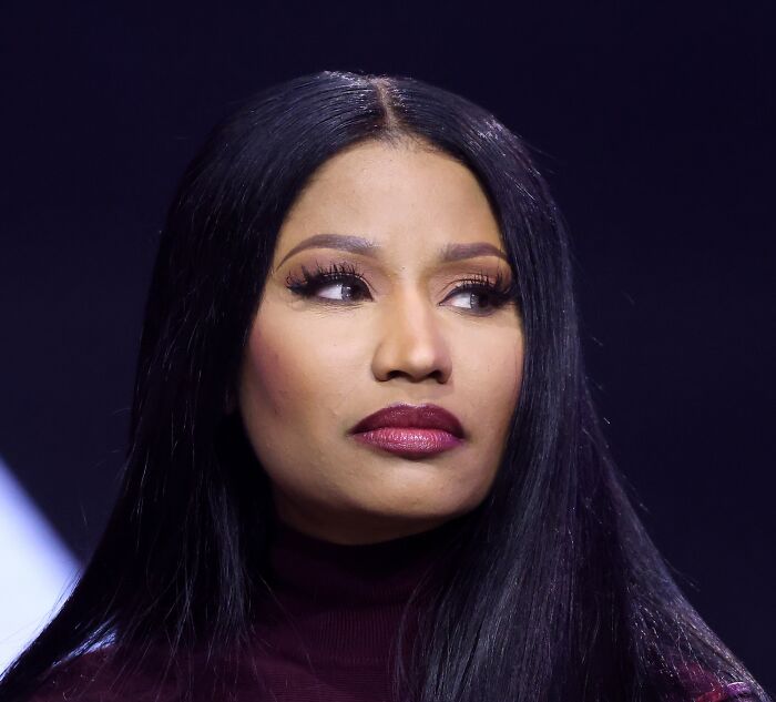 Nicki Minaj, a celebrity whose fame might have run out, looks away with a serious expression.