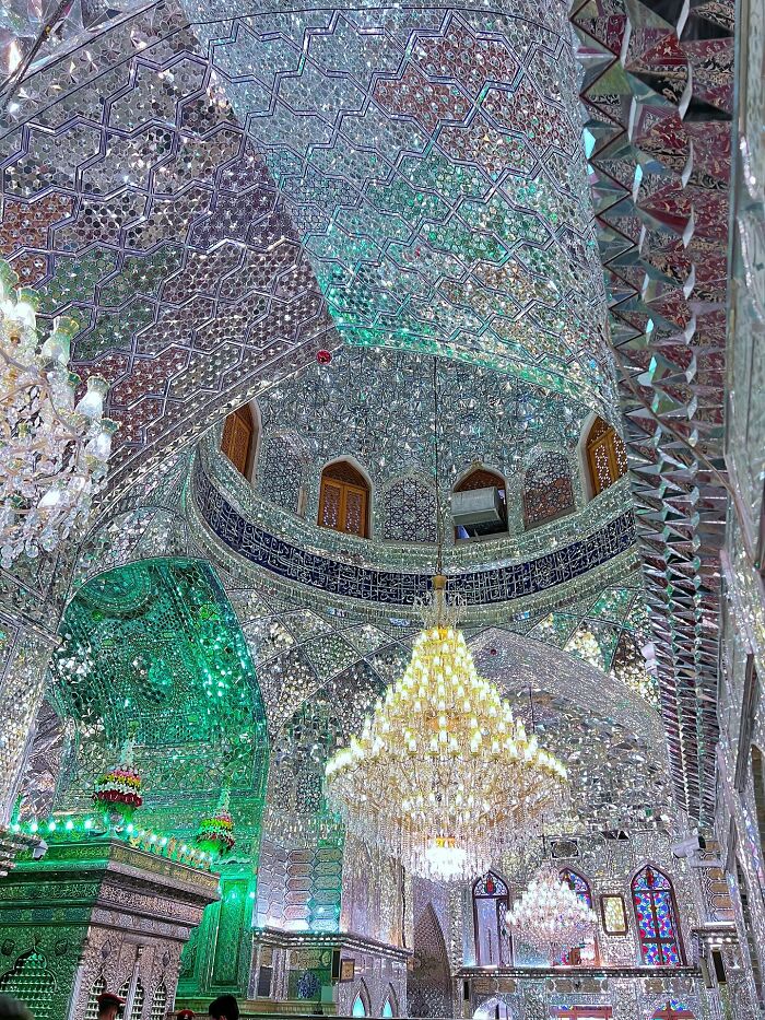 Interior of Persian mosque with sparkling mirrored mosaic and grand chandelier