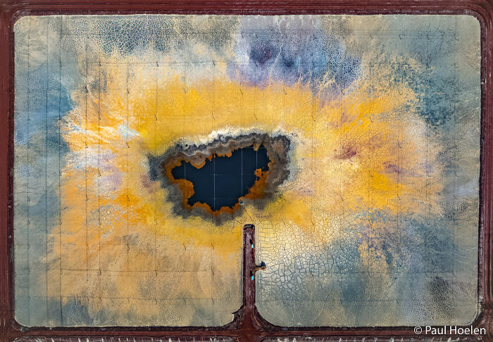 Vibrant abstract aerial view of a salt pond with a dark blue center, part of the Au Photo Contest.