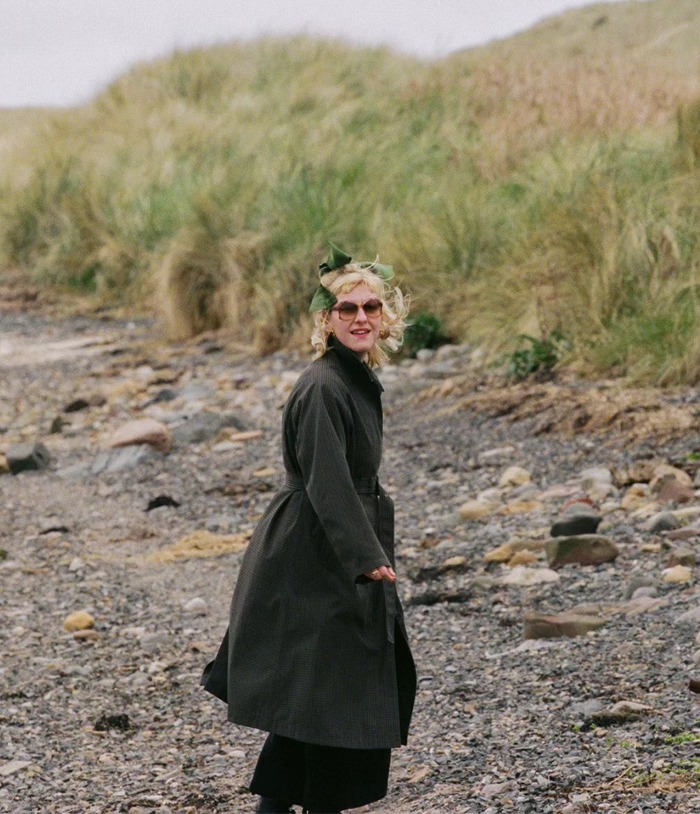 A woman looking over her shoulder, on a rocky beach, contemplating her mistake and how it affected her marriage. A woman looking over her shoulder, on a rocky beach, contemplating her mistake and how it affected her marriage.