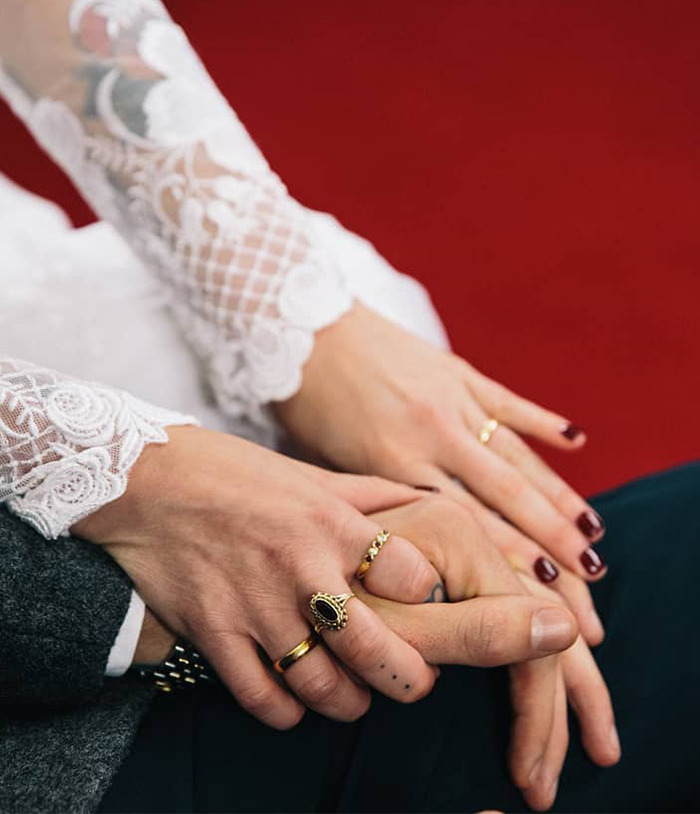Close-up of a married couple's hands with rings, representing the bond in their marriage. Close-up of a married couple's hands with rings, representing the bond in their marriage.