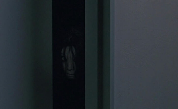 A creepy face peers from a dark doorway, an unexplainable experience that people can't explain.