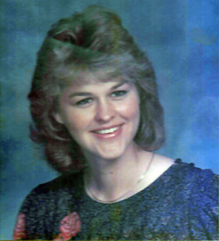 A smiling woman with feathered hair, a classic 80s look, representing unsolved mysteries that were later solved.