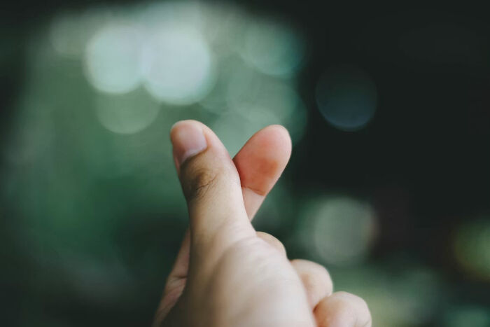 A hand forming a finger heart gesture. A moment of calm after someone simply couldn't take it anymore and snapped.