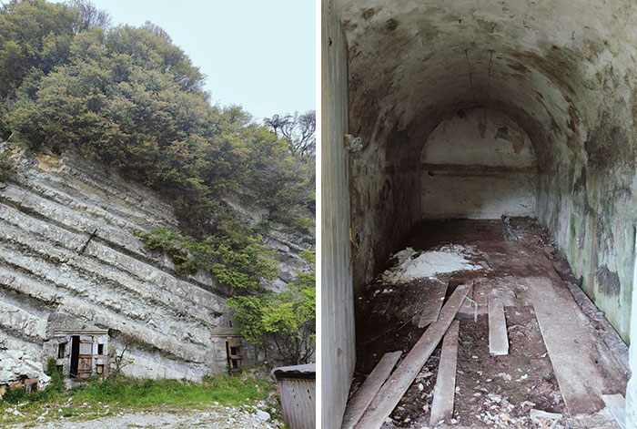 Forgotten places with abandoned caves in rocky hillside covered by greenery