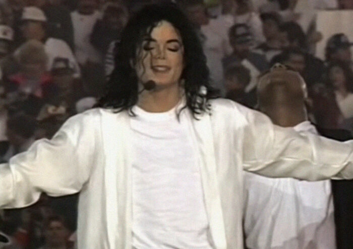Michael Jackson performing on stage, embodying a memorable personality with useless facts.