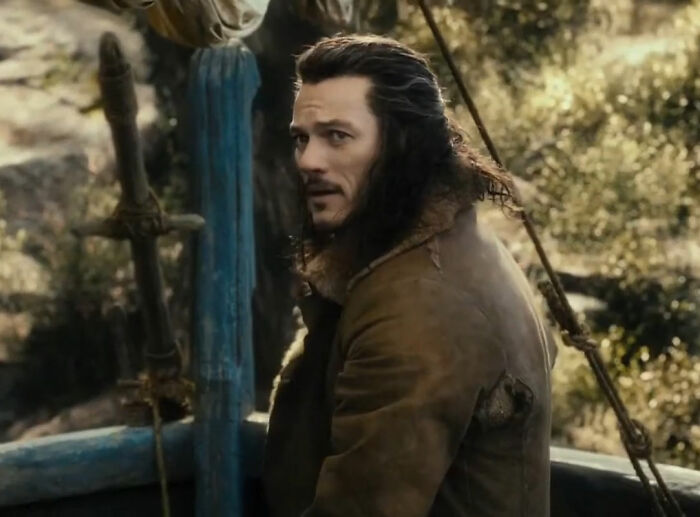 Luke Evans smiling in period costume scene from The Hobbit film Luke Evans smiling in period costume scene from The Hobbit film