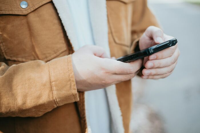 Close-up of man holding phone representing suspicious partner phone discoveries