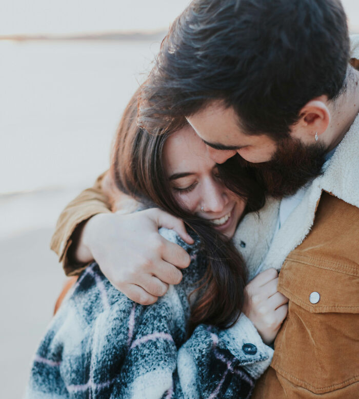 A smiling couple embracing each other tightly. Women decided to marry their partner.