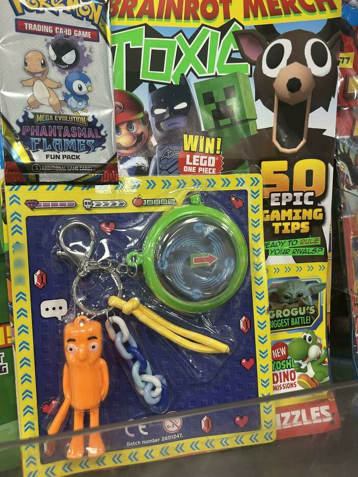 A bizarre collection of merchandise including a Pokemon pack, a magazine, and a keychain set.