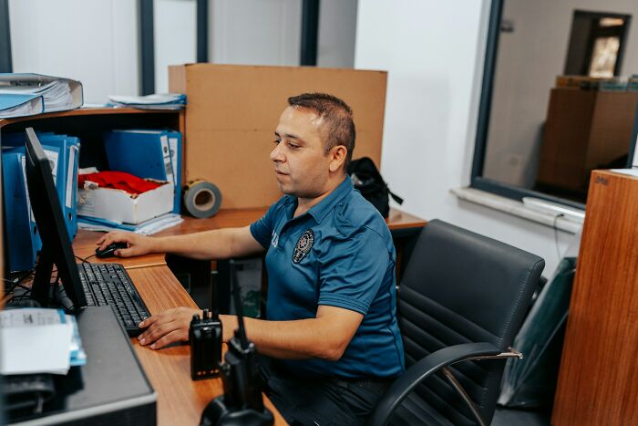 Man focused working on computer at office desk representing productive coping
