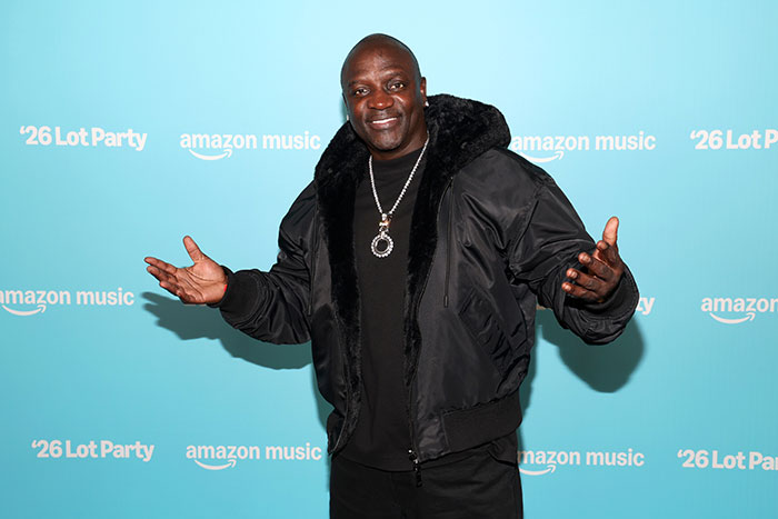 Akon posing in black jacket at Amazon music lot party event