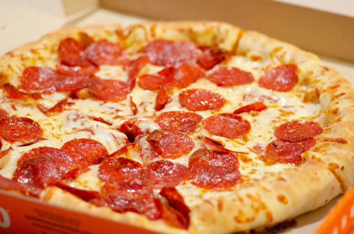A delicious pepperoni pizza in a box, a potential treat for teachers after a long day.