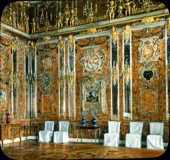 A magnificent Amber Room, a lost treasure, adorned with intricate gold and amber panels, reflecting light in a historic palace.
