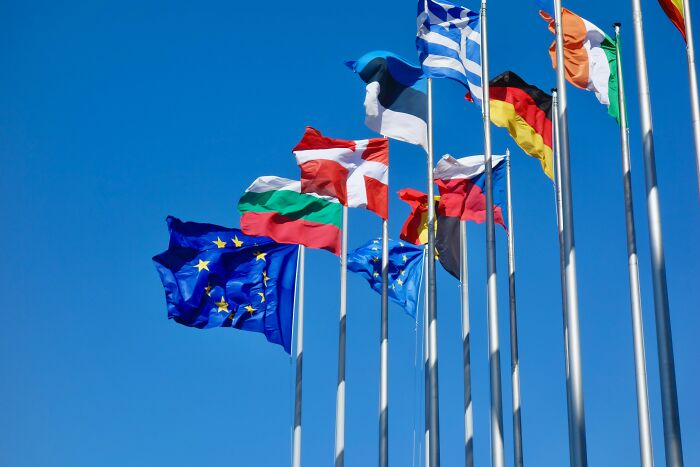 Flags of European countries and the EU fluttering against a clear blue sky for European pub quiz