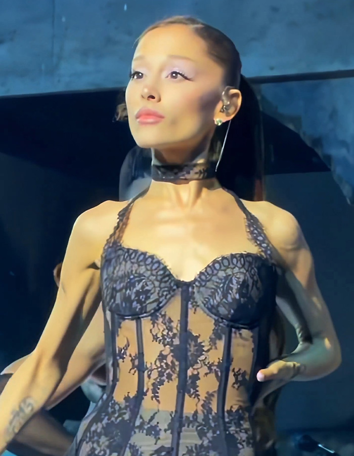 Ariana Grande on stage during her tour, prompting fan concern.