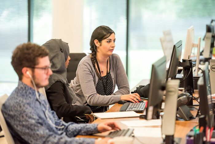 Multicultural team working focused at computers about mass walkouts