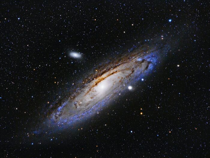 The Andromeda Galaxy glowing in the dark expanse of space, representing cool and surprising facts about the universe.