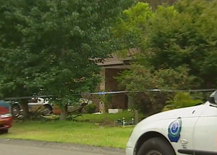 Crime scene outside house in Australia with police tape and cars