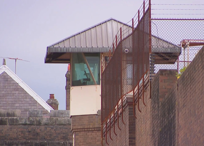 Prison watchtower with fencing and security measures