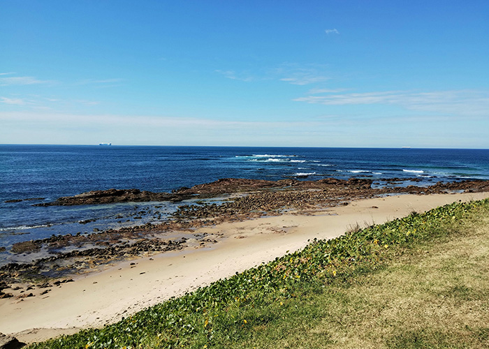 Rocky beach under blue sky on Australia's Central Coast