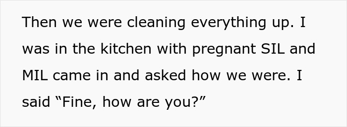 Couple cleaning up after gathering while MIL checks on them in kitchen