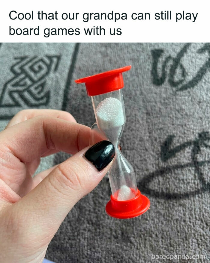 A blursed meme displays a hand holding a tiny hourglass, ironically suggesting a long game with a short timer.