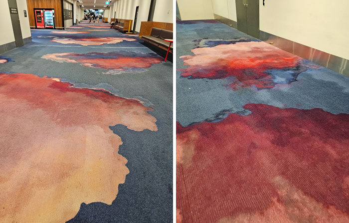Carpet design fail with stain-like patterns that look like spills in hallway
