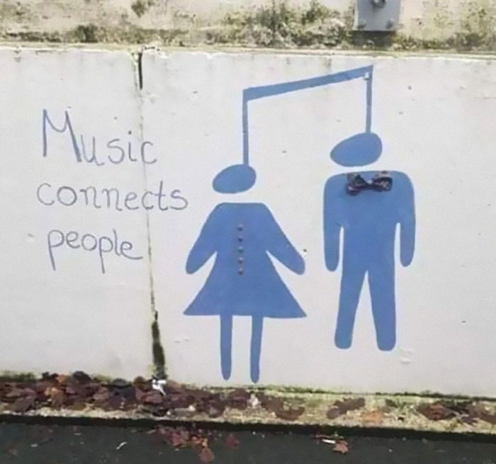 Graffiti art of music notes as human figures connecting with caption music connects people