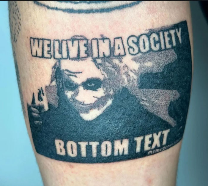 A detailed tattoo of the Joker meme We Live in a Society on a person's leg, an example of questionable tattoo ideas.