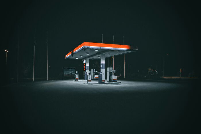 Gas station lit up at night representing American convenience and fuel access