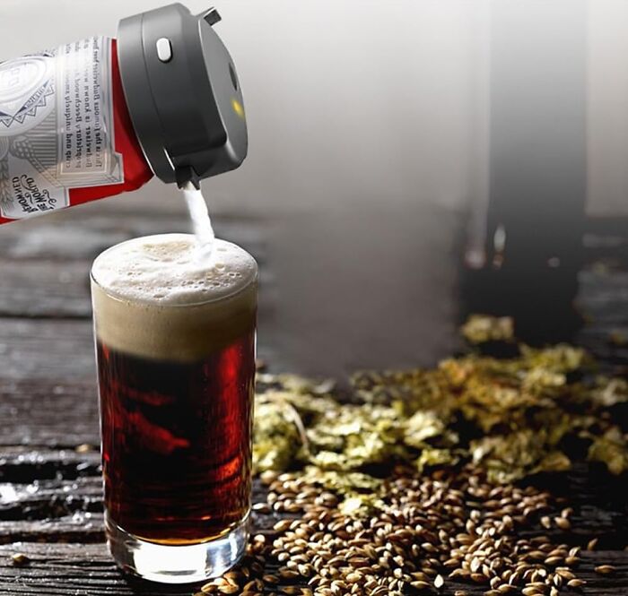 Beer pouring from a can into a glass, surrounded by hops and barley, a last minute Father's Day gift.