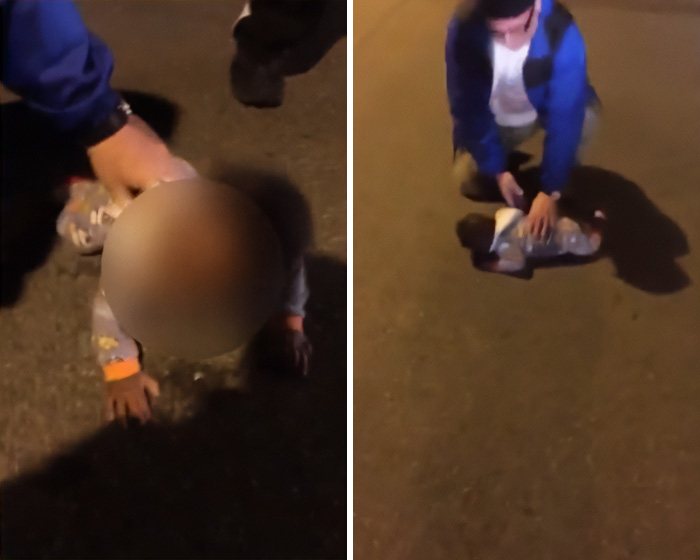A biker kneels next to a baby found crawling out at night on a dark street.