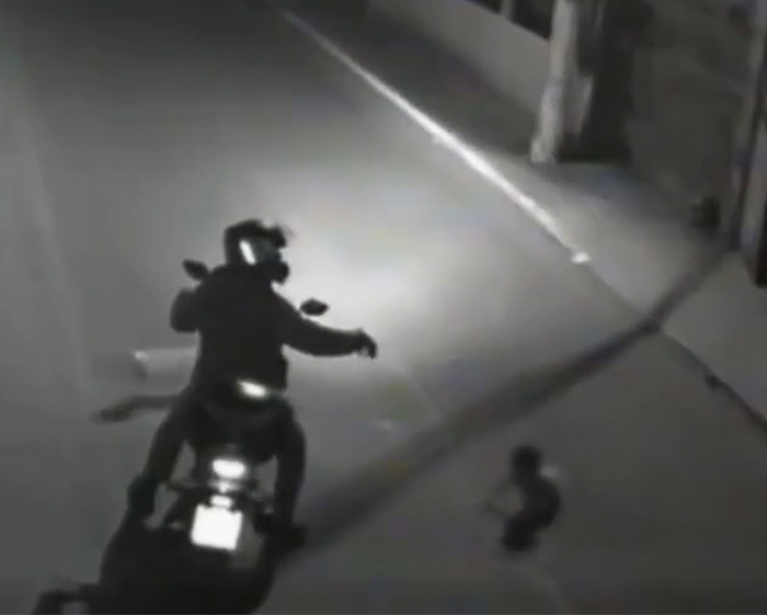 Biker finds baby crawling out at night, a moment caught on surveillance footage.