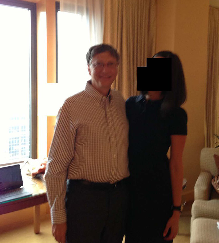 Bill Gates standing with a woman with face blacked out in a room Bill Gates standing with a woman with face blacked out in a room