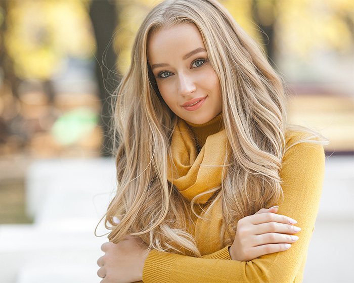 Blonde woman with scarf representing female attractiveness outdoors Blonde woman with scarf representing female attractiveness outdoors
